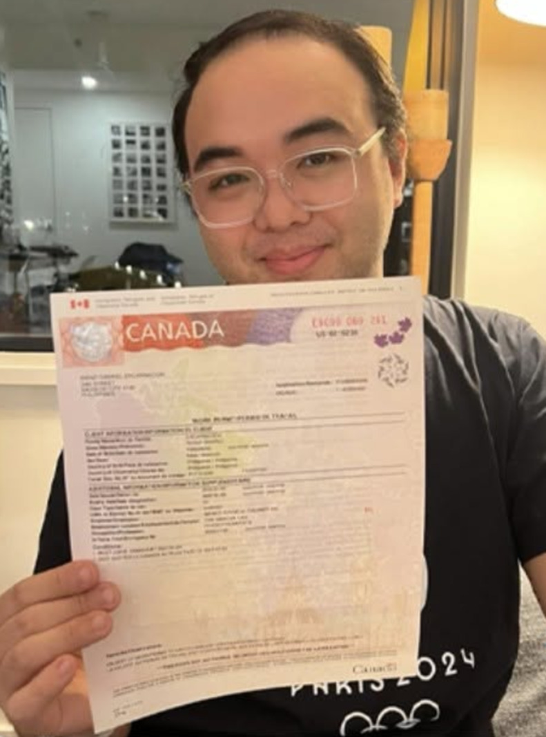 Renzi holding the Canadian work permit he received